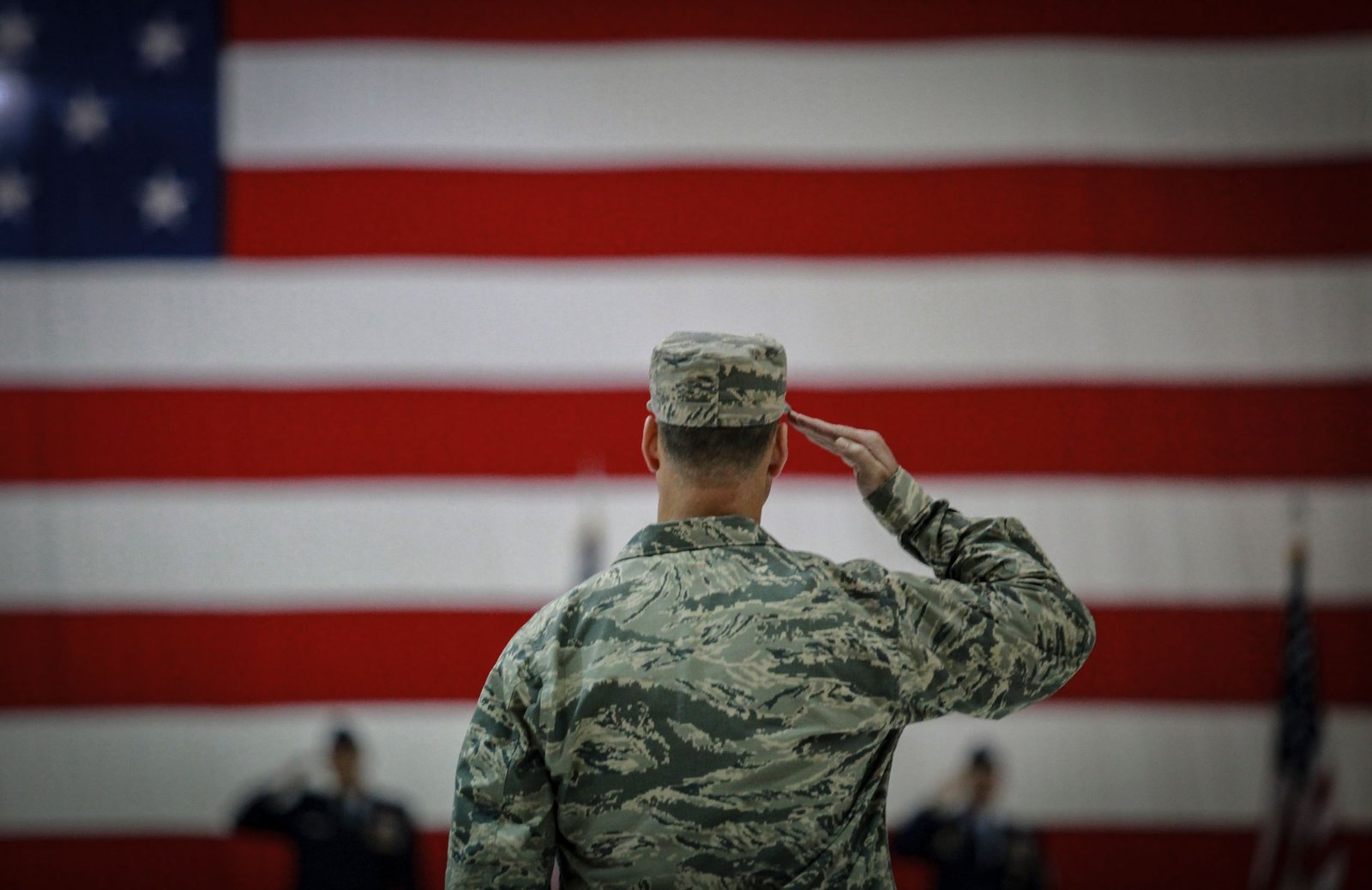 Veteran saluting the American flag